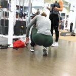 Beautiful Woman with Big Butt Exercising in Green Spandex